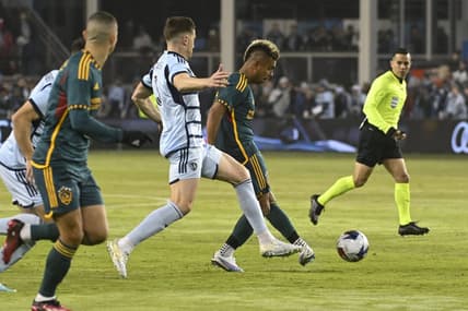 Mar 11, 2023; Kansas City, Kansas, USA; Sporting Kansas City defender Andreu Fontas (3) and Los Angeles Galaxy midfielder Efrain Alvares (7) battle for control of the ball at Children's Mercy Park. Mandatory Credit: Joe Puetz-USA TODAY Sports