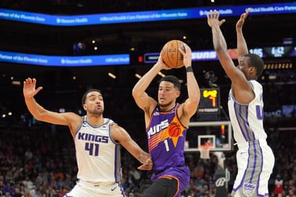 Mar 11, 2023; Phoenix, Arizona, USA; Phoenix Suns guard Devin Booker (1) drives against Sacramento Kings forward Trey Lyles (41) and Sacramento Kings forward Harrison Barnes (40) during the second half at Footprint Center. Mandatory Credit: Joe Camporeale-USA TODAY Sports