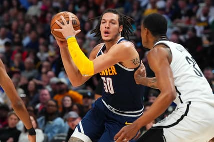 Mar 12, 2023; Denver, Colorado, USA; Denver Nuggets forward Aaron Gordon (50) drives at Brooklyn Nets center Nic Claxton (33) in the second quarter at Ball Arena. Mandatory Credit: Ron Chenoy-USA TODAY Sports