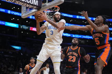 Mar 12, 2023; Los Angeles, California, USA; Los Angeles Lakers forward Anthony Davis (3) rebounds the ball against New York Knicks center Mitchell Robinson (23) and guard Immanuel Quickley (5) in the second half at Crypto.com Arena. Mandatory Credit: Kirby Lee-USA TODAY Sports