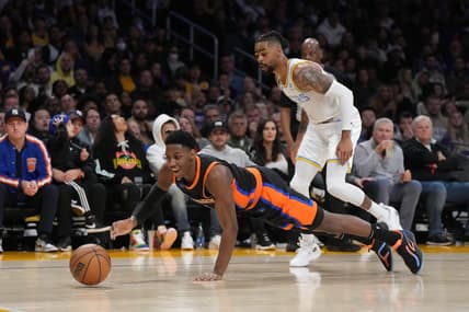 Mar 12, 2023; Los Angeles, California, USA; New York Knicks guard RJ Barrett (9) and Los Angeles Lakers guard D'Angelo Russell (1) reach for the ball in the second half at Crypto.com Arena. Mandatory Credit: Kirby Lee-USA TODAY Sports