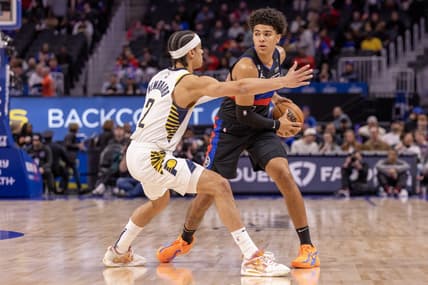 Mar 13, 2023; Detroit, Michigan, USA; Detroit Pistons guard Killian Hayes (7) controls the ball in front of Indiana Pacers guard Andrew Nembhard (2) during the first quarter at Little Caesars Arena. Mandatory Credit: David Reginek-USA TODAY Sports