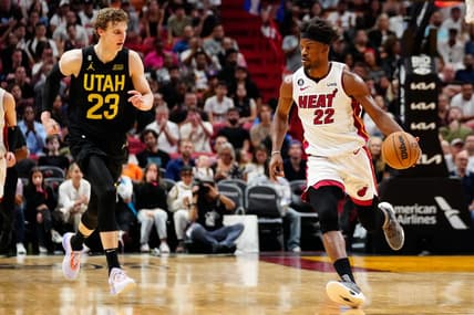 Mar 13, 2023; Miami, Florida, USA; Miami Heat forward Jimmy Butler (22) dribbles the ball past Utah Jazz forward Lauri Markkanen (23) during the fourth quarter at Miami-Dade Arena. Mandatory Credit: Rich Storry-USA TODAY Sports