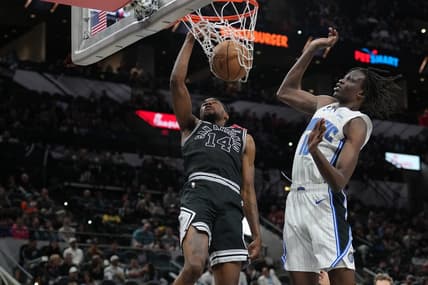 Mar 14, 2023; San Antonio, Texas, USA;  San Antonio Spurs guard Blake Wesley (14) dunks against Orlando Magic center Bol Bol (10) in the first half at the AT&T Center. Mandatory Credit: Daniel Dunn-USA TODAY Sports
