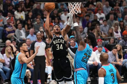 Mar 14, 2023; Phoenix, Arizona, USA; Milwaukee Bucks forward Giannis Antetokounmpo (34) shoots over Phoenix Suns center Deandre Ayton (22) during the first half at Footprint Center. Mandatory Credit: Joe Camporeale-USA TODAY Sports