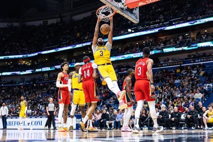 Mar 14, 2023; New Orleans, Louisiana, USA; Los Angeles Lakers forward Anthony Davis (3) dunks the ball against New Orleans Pelicans forward Brandon Ingram (14) during the second half at Smoothie King Center. Mandatory Credit: Stephen Lew-USA TODAY Sports