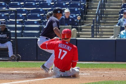 Mar 15, 2023; Tampa, Florida, USA; Philadelphia Phillies first baseman Rhys Hoskins (17) steals home plate in front of New York Yankees pitcher Carlos Gomez (33) during the first inning at George M. Steinbrenner Field. Mandatory Credit: Mike Watters-USA TODAY Sports