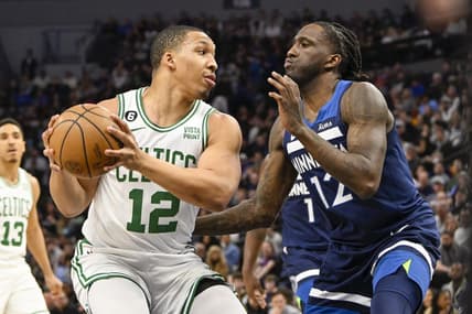 Mar 15, 2023; Minneapolis, Minnesota, USA;  Boston Celtics forward Grant Williams (12) protects the ball from Minnesota Timberwolves forward Taurean Prince (12) in the first quarter at Target Center. Mandatory Credit: Nick Wosika-USA TODAY Sports