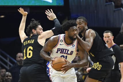 Mar 15, 2023; Cleveland, Ohio, USA; Philadelphia 76ers center Joel Embiid (21) looks to pass while defended by Cleveland Cavaliers forward Cedi Osman (16) and forward Evan Mobley (4) in the second quarter at Rocket Mortgage FieldHouse. Mandatory Credit: David Richard-USA TODAY Sports