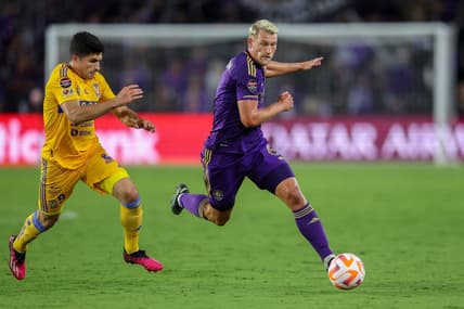Mar 15, 2023; Orlando, FL, USA;   Tigres UANL forward Nicolas Ibanez (9) and Orlando City SC defender Robin Jansson (6) battle for the ball in the second half during the CONCACAF Champions League at Exploria Stadium. Mandatory Credit: Nathan Ray Seebeck-USA TODAY Sports