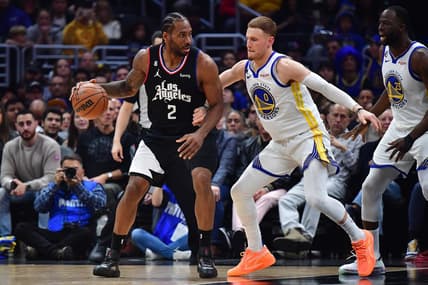 Mar 15, 2023; Los Angeles, California, USA; Los Angeles Clippers forward Kawhi Leonard (2) moves the ball against Golden State Warriors guard Donte DiVincenzo (0) during the first half at Crypto.com Arena. Mandatory Credit: Gary A. Vasquez-USA TODAY Sports