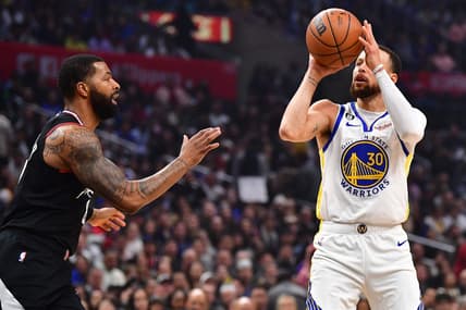 Mar 15, 2023; Los Angeles, California, USA; Golden State Warriors guard Stephen Curry (30) shoots against Los Angeles Clippers forward Marcus Morris Sr. (8) during the first half at Crypto.com Arena. Mandatory Credit: Gary A. Vasquez-USA TODAY Sports