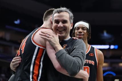 Mar 16, 2023; Sacramento, CA, USA; Princeton Tigers head coach Mitch Henderson celebrates the victory against the Arizona Wildcats with guard Matt Allocco (14) at Golden 1 Center. Mandatory Credit: Kelley L Cox-USA TODAY Sports