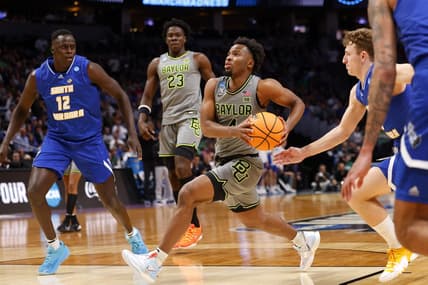 Mar 17, 2023; Denver, CO, USA;  Baylor Bears guard LJ Cryer (4) drives to the basket as UC Santa Barbara Gauchos forward Evans Kipruto (12) defends during the second half in the first round of the 2023 NCAA men   s basketball tournament at Ball Arena. Mandatory Credit: Michael Ciaglo-USA TODAY Sports