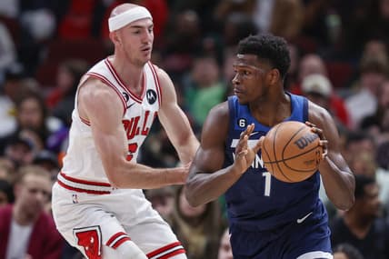 Mar 17, 2023; Chicago, Illinois, USA; Minnesota Timberwolves guard Anthony Edwards (1) is defended by Chicago Bulls guard Alex Caruso (6) during the first half at United Center. Mandatory Credit: Kamil Krzaczynski-USA TODAY Sports
