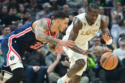 Mar 17, 2023; Cleveland, Ohio, USA; Washington Wizards forward Kyle Kuzma (33) and Cleveland Cavaliers guard Caris LeVert (3) go for a loose ball during the first half at Rocket Mortgage FieldHouse. Mandatory Credit: Ken Blaze-USA TODAY Sports