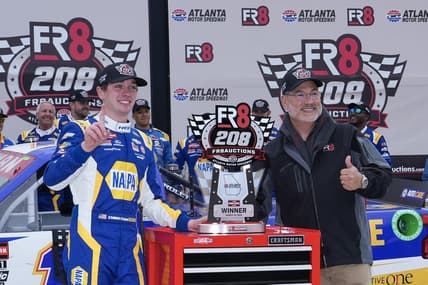 Mar 18, 2023; Hampton, Georgia, USA; NASCAR Craftsman Truck Series driver Christian Eckes (19) (left) celebrates in Victory Lane after winning the FR8 208 at Atlanta Motor Speedway. Mandatory Credit: David Yeazell-USA TODAY Sports