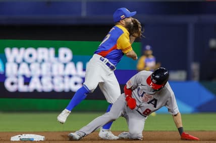 Mar 18, 2023; Miami, Florida, USA; Venezuela second baseman Jose Altuve (27) turns a double play over USA shortstop Trea Turner (8) during the second inning at LoanDepot Park. Mandatory Credit: Sam Navarro-USA TODAY Sports