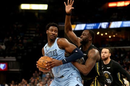 Mar 18, 2023; Memphis, Tennessee, USA; Memphis Grizzlies forward Jaren Jackson Jr. (13) spins toward the basket as Golden State Warriors forward Draymond Green (23) defends during the first half at FedExForum. Mandatory Credit: Petre Thomas-USA TODAY Sports
