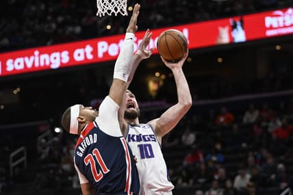 Mar 18, 2023; Washington, District of Columbia, USA; Sacramento Kings forward Domantas Sabonis (10) shoots over Washington Wizards center Daniel Gafford (21) during the first half at Capital One Arena. Mandatory Credit: Brad Mills-USA TODAY Sports
