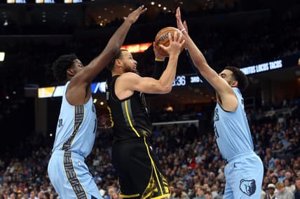 Mar 18, 2023; Memphis, Tennessee, USA; Golden State Warriors guard Stephen Curry (30) drives to the basket between Memphis Grizzlies forward Jaren Jackson Jr. (13) and guard Tyus Jones (21) during the second half at FedExForum. Mandatory Credit: Petre Thomas-USA TODAY Sports