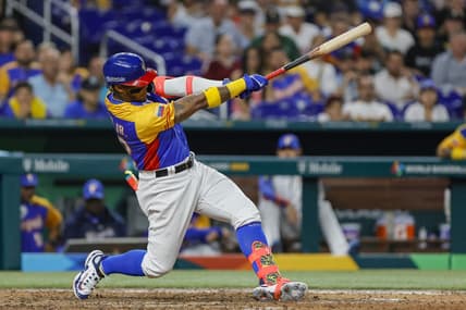 Mar 18, 2023; Miami, Florida, USA; Venezuela center fielder Ronald Acuna Jr. (42) hits a double during the eighth inning against the USA at LoanDepot Park. Mandatory Credit: Sam Navarro-USA TODAY Sports