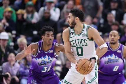 Mar 18, 2023; Salt Lake City, Utah, USA; Boston Celtics forward Jayson Tatum (0) posts up against Utah Jazz guard Ochai Agbaji (30) in the fourth quarter at Vivint Arena. Mandatory Credit: Rob Gray-USA TODAY Sports