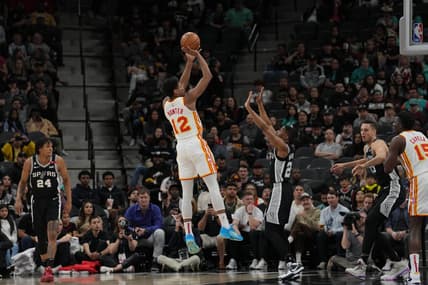 Mar 19, 2023; San Antonio, Texas, USA; Atlanta Hawks forward De'Andre Hunter (12) shoots over San Antonio Spurs guard Malaki Branham (22) in the first half at the AT&T Center. Mandatory Credit: Daniel Dunn-USA TODAY Sports