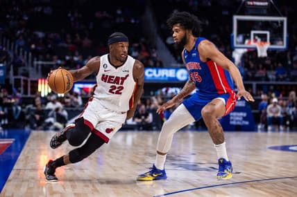 Mar 19, 2023; Detroit, Michigan, USA; Miami Heat forward Jimmy Butler (22) drives to the basket against Detroit Pistons forward Marvin Bagley III (35) in the first quarter at Little Caesars Arena. Mandatory Credit: Allison Farrand-USA TODAY Sports