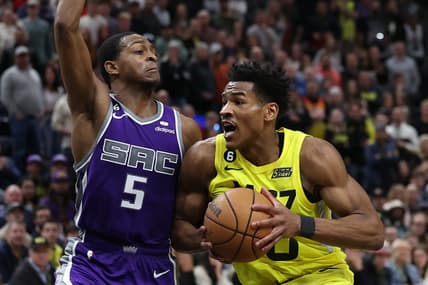 Mar 20, 2023; Salt Lake City, Utah, USA; Utah Jazz guard Ochai Agbaji (30) drives against Sacramento Kings guard De'Aaron Fox (5) in the fourth quarter at Vivint Arena. Mandatory Credit: Rob Gray-USA TODAY Sports