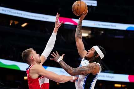 Mar 21, 2023; Orlando, Florida, USA; Orlando Magic guard Markelle Fultz (20) shoots over Washington Wizards center Kristaps Porzingis (6) during the first quarter at Amway Center. Mandatory Credit: Rich Storry-USA TODAY Sports