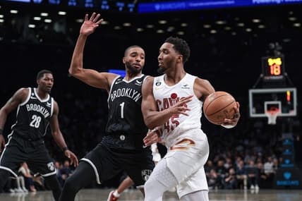 Mar 21, 2023; Brooklyn, New York, USA; Cleveland Cavaliers guard Donovan Mitchell (45) dribbles against Brooklyn Nets forward Mikal Bridges (1) during the first quarter at Barclays Center. Mandatory Credit: Vincent Carchietta-USA TODAY Sports