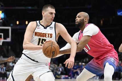 Mar 22, 2023; Washington, District of Columbia, USA; Denver Nuggets center Nikola Jokic (15) dribbles as Washington Wizards forward Taj Gibson (67) defends during the first half at Capital One Arena. Mandatory Credit: Brad Mills-USA TODAY Sports