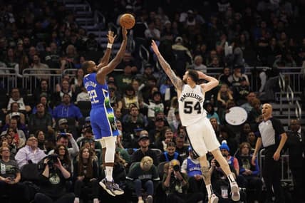 Mar 22, 2023; Milwaukee, Wisconsin, USA;  Milwaukee Bucks forward Khris Middleton (22) shoots against San Antonio Spurs forward Sandro Mamukelashvili (54) during the fourth quarter at Fiserv Forum. Mandatory Credit: Jeff Hanisch-USA TODAY Sports