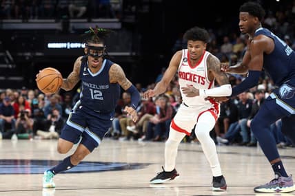 Mar 22, 2023; Memphis, Tennessee, USA; Memphis Grizzlies guard Ja Morant (12) drives to the basket as Houston Rockets guard Jalen Green (4) defends during the second half at FedExForum. Mandatory Credit: Petre Thomas-USA TODAY Sports
