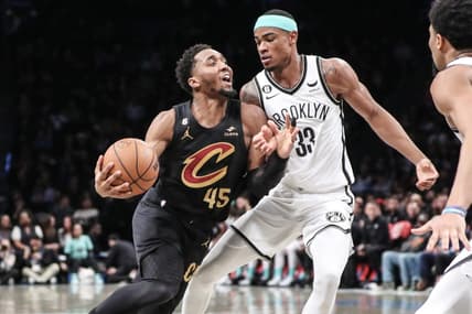 Mar 23, 2023; Brooklyn, New York, USA;  Cleveland Cavaliers guard Donovan Mitchell (45) looks to drive past Brooklyn Nets center Nic Claxton (33) in the second quarter at Barclays Center. Mandatory Credit: Wendell Cruz-USA TODAY Sports