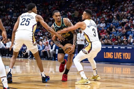 Mar 23, 2023; New Orleans, Louisiana, USA;  Charlotte Hornets forward P.J. Washington (25) is fouled by New Orleans Pelicans guard Trey Murphy III (25) and guard CJ McCollum (3) during the first half at Smoothie King Center. Mandatory Credit: Stephen Lew-USA TODAY Sports