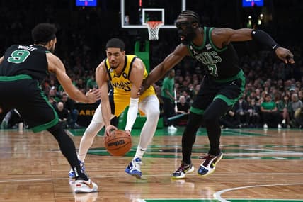Mar 24, 2023; Boston, Massachusetts, USA;  Indiana Pacers guard Tyrese Haliburton (0) controls the ball while Boston Celtics guard Derrick White (9) and guard Jaylen Brown (7) defend during the first half at TD Garden. Mandatory Credit: Bob DeChiara-USA TODAY Sports