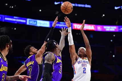 Mar 24, 2023; Los Angeles, California, USA; Oklahoma City Thunder guard Shai Gilgeous-Alexander (2) shoots agaisnt Los Angeles Lakers forward Jarred Vanderbilt (2) forward Troy Brown Jr. (7) during the first half at Crypto.com Arena. Mandatory Credit: Gary A. Vasquez-USA TODAY Sports