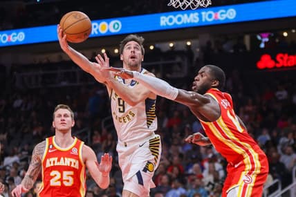 Mar 25, 2023; Atlanta, Georgia, USA; Indiana Pacers guard T.J. McConnell (9) shoots past Atlanta Hawks forward AJ Griffin (14) in the second quarter at State Farm Arena. Mandatory Credit: Brett Davis-USA TODAY Sports