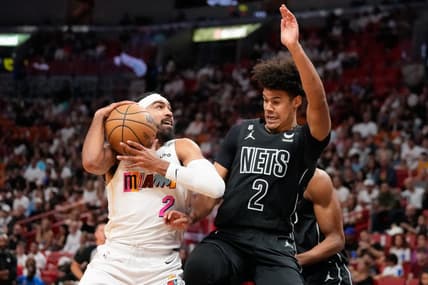 Mar 25, 2023; Miami, Florida, USA; Brooklyn Nets forward Cameron Johnson (2) fouls Miami Heat guard Gabe Vincent (2) during the first quarter at Miami-Dade Arena. Mandatory Credit: Rich Storry-USA TODAY Sports