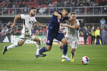 Mar 25, 2023; Washington, District of Columbia, USA; New England Revolution forward Bobby Wood (17) battles for the ball with D.C. United midfielder Russell Canouse (6) in the first half at Audi Field. Mandatory Credit: Amber Searls-USA TODAY Sports