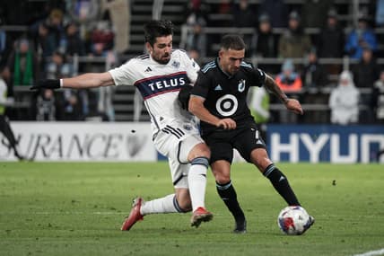 Mar 25, 2023; Saint Paul, Minnesota, USA; Minnesota United FC midfielder Franco Fragapane (7) in action against Vancouver Whitecaps forward Brian White (24) during the first half at Allianz Field. Mandatory Credit: Matt Blewett-USA TODAY Sports