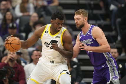Mar 25, 2023; Sacramento, California, USA; Utah Jazz center Udoka Azubuike (left) dribbles against Sacramento Kings forward Domantas Sabonis (right) during the first quarter at Golden 1 Center. Mandatory Credit: Darren Yamashita-USA TODAY Sports