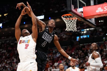 Mar 25, 2023; Miami, Florida, USA; Miami Heat guard Kyle Lowry (7) and Brooklyn Nets guard Edmond Sumner (4) compete for a rebound during the second half at Miami-Dade Arena. Mandatory Credit: Rich Storry-USA TODAY Sports