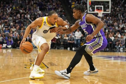 Mar 25, 2023; Sacramento, California, USA; Utah Jazz guard Talen Horton-Tucker (left) dribbles against Sacramento Kings guard Davion Mitchell (15) during the fourth quarter at Golden 1 Center. Mandatory Credit: Darren Yamashita-USA TODAY Sports
