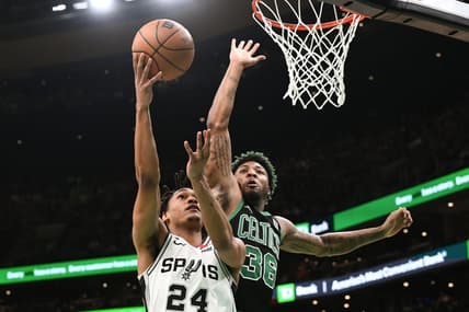 Mar 26, 2023; Boston, Massachusetts, USA; San Antonio Spurs guard Devin Vassell (24) attempts a layup against Boston Celtics guard Marcus Smart (36) during the first quarter at the TD Garden. Mandatory Credit: Brian Fluharty-USA TODAY Sports