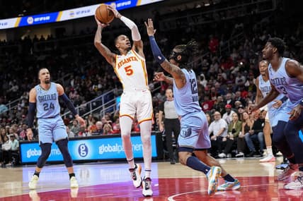 Mar 26, 2023; Atlanta, Georgia, USA; Atlanta Hawks guard Dejounte Murray (5) looks to shoot against Memphis Grizzlies guard Ja Morant (12) during the first half at State Farm Arena. Mandatory Credit: Dale Zanine-USA TODAY Sports