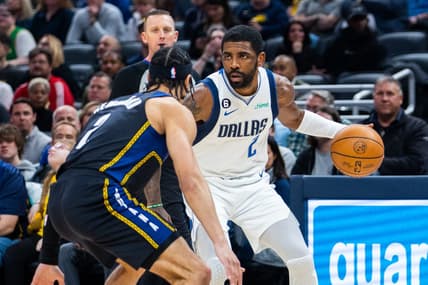Mar 27, 2023; Indianapolis, Indiana, USA; Dallas Mavericks guard Kyrie Irving (2) dribbles the ball while Indiana Pacers guard Andrew Nembhard (2) defends in the first quarter at Gainbridge Fieldhouse. Mandatory Credit: Trevor Ruszkowski-USA TODAY Sports
