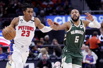 Mar 27, 2023; Detroit, Michigan, USA;  Detroit Pistons guard Jaden Ivey (23) dribbles on Milwaukee Bucks guard Jevon Carter (5) in the first half at Little Caesars Arena. Mandatory Credit: Rick Osentoski-USA TODAY Sports